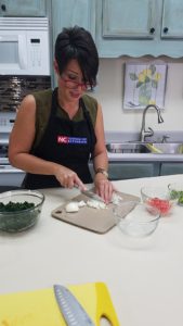 Extension Director cutting onions on a cutting board